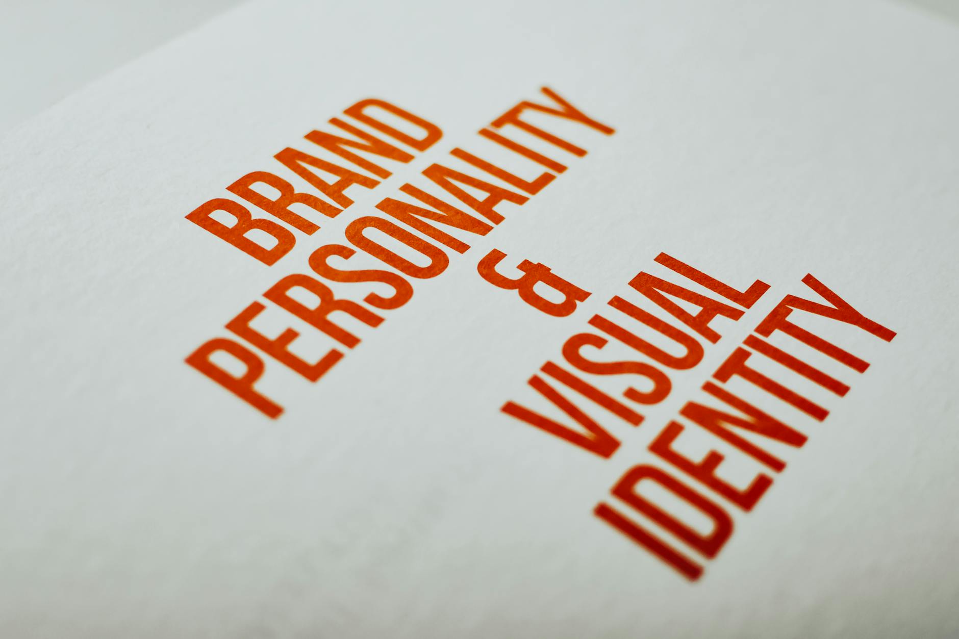 Zbliżenie na napis Brand Personality & Visual Identity na białej kartce
