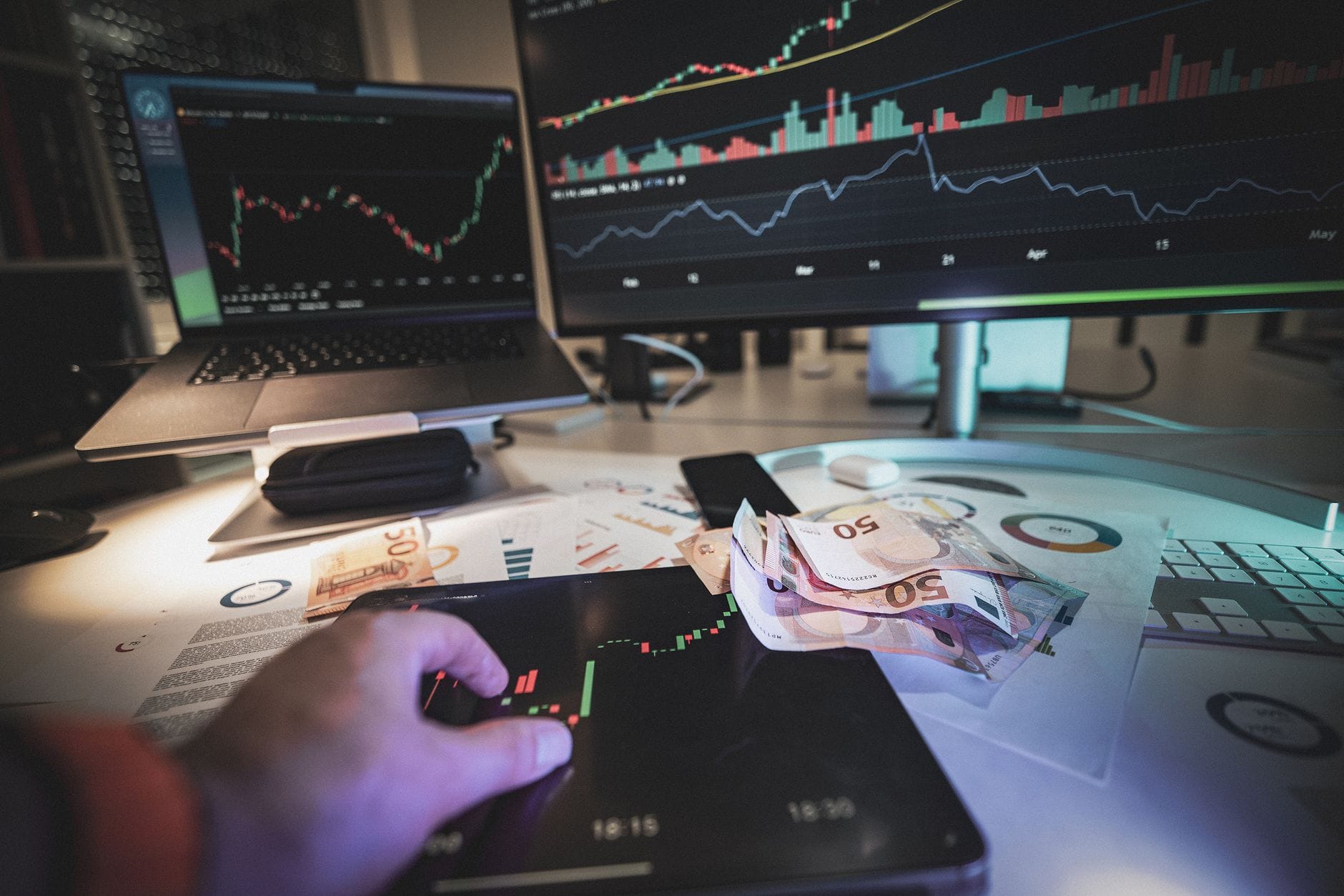 Nowoczesne stanowisko tradera z wykresami cen i banknotami euro